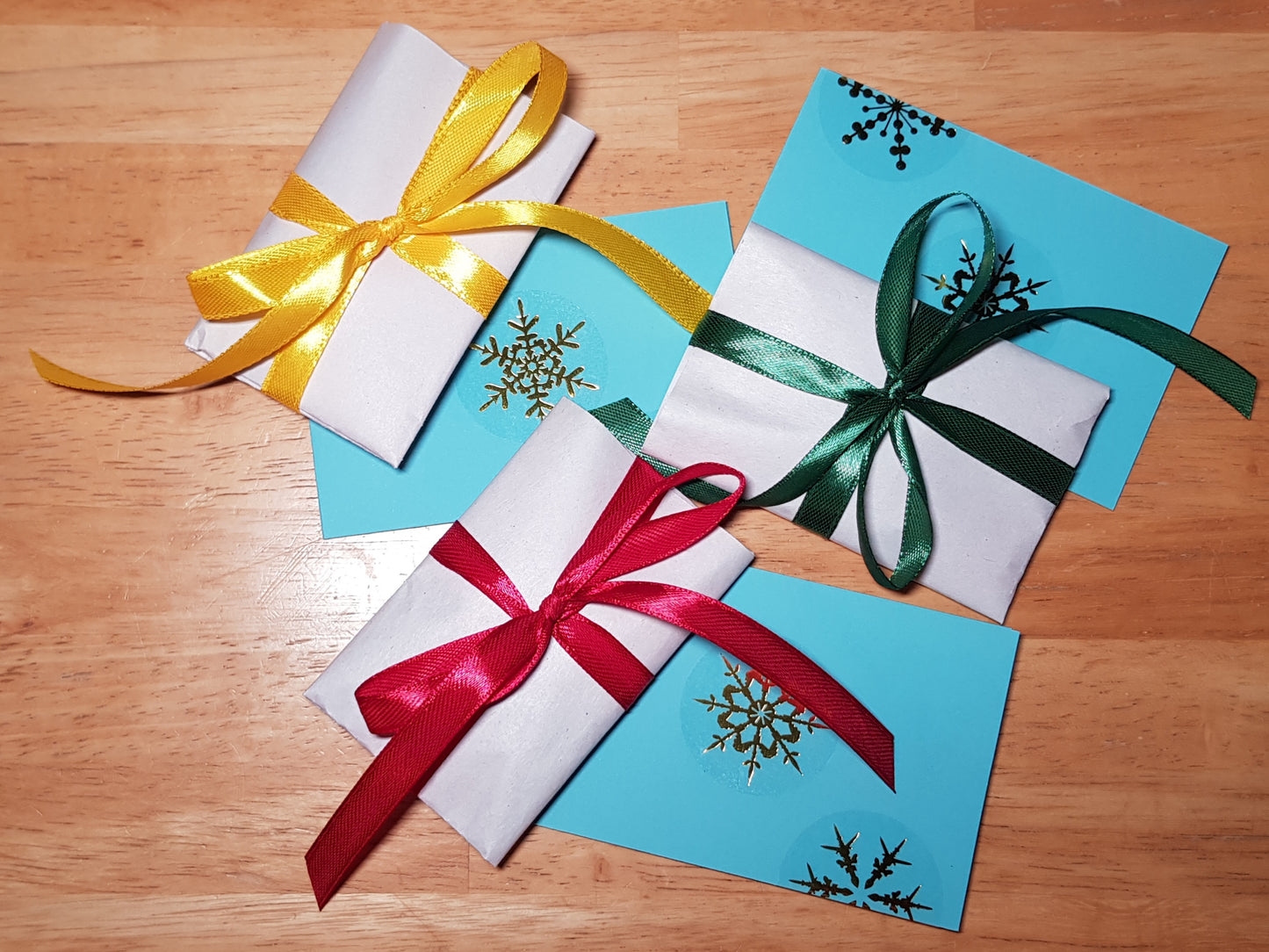 a couple of wrapped presents sitting on top of a wooden table