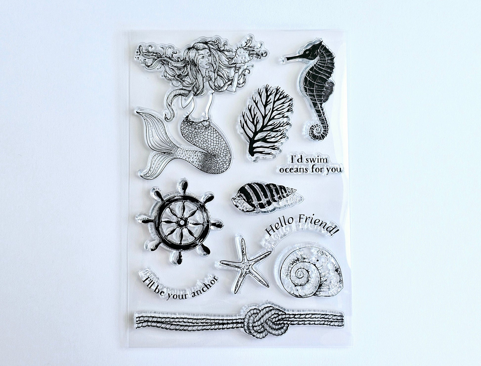 Beautiful summer stamp set featuring a mermaid seahorse ships helm wheel conch starfish sea rope sea fan sea coral and friendly messages.