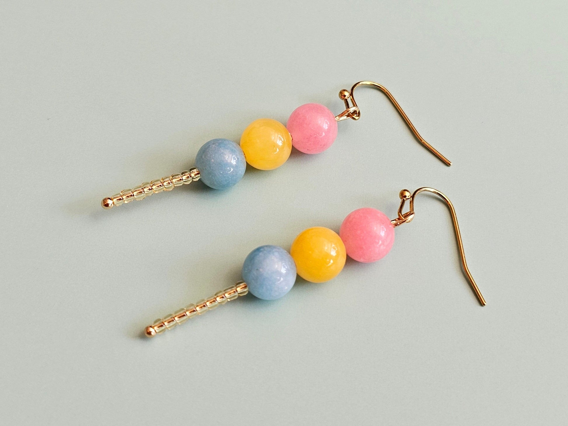 Pansexual earrings with hypoallergenic titanium or surgical steel ear wires.