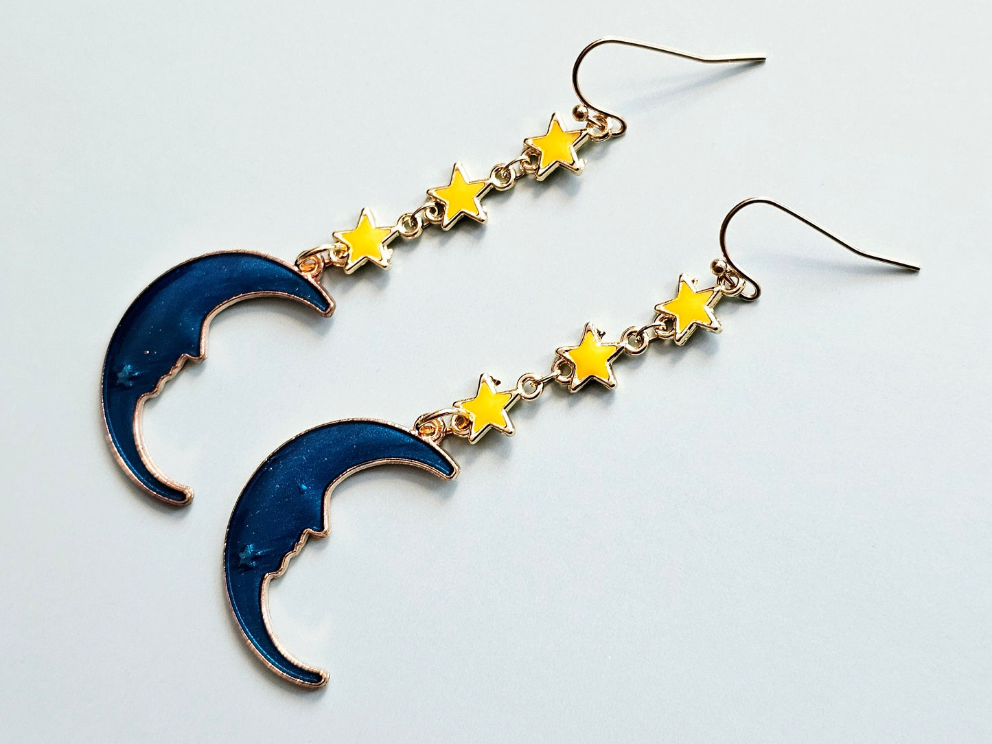 Yellow gold stars and sapphire blue crescent moon earrings.