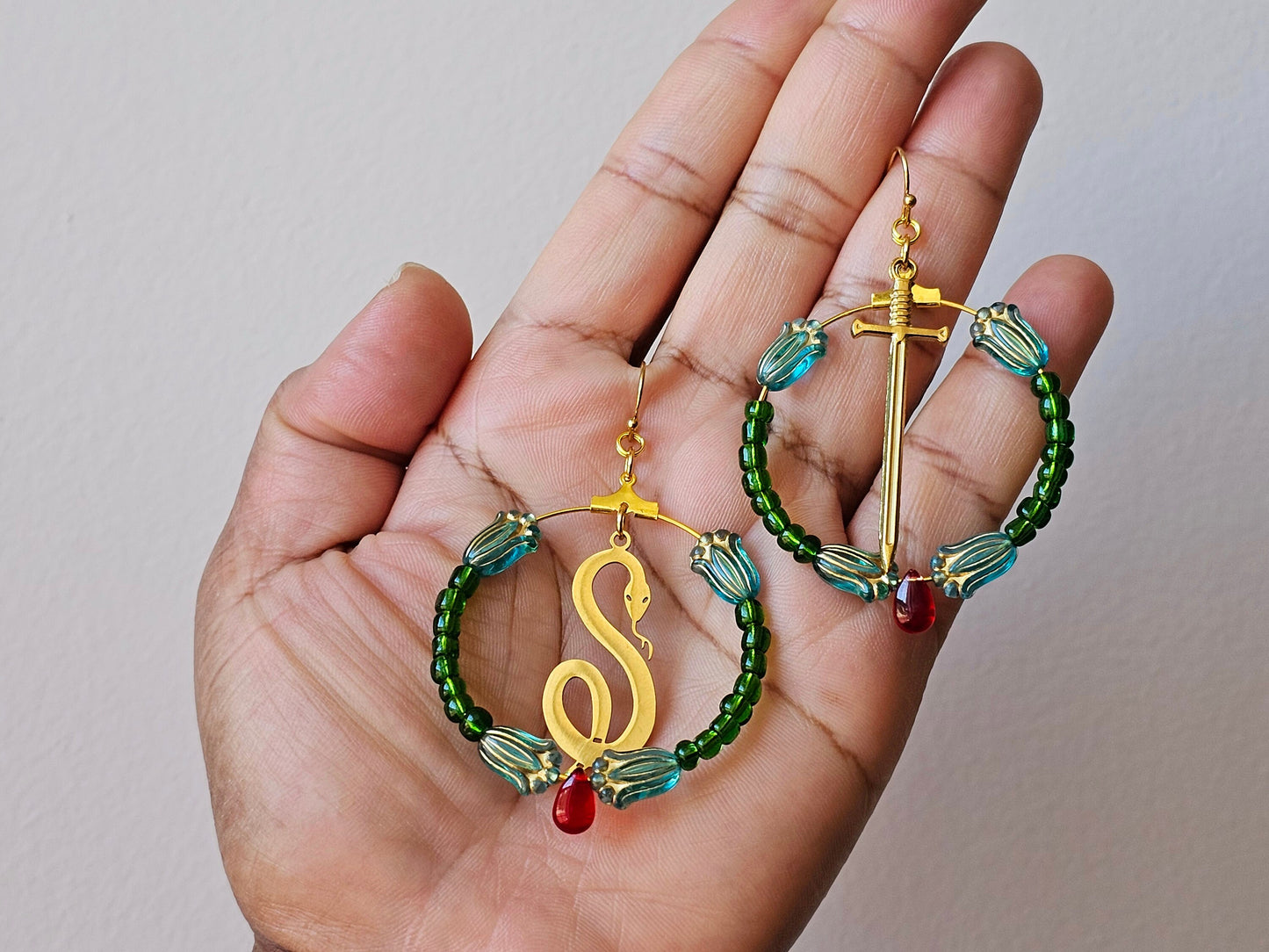 Gold plated serpent and sword earrings.