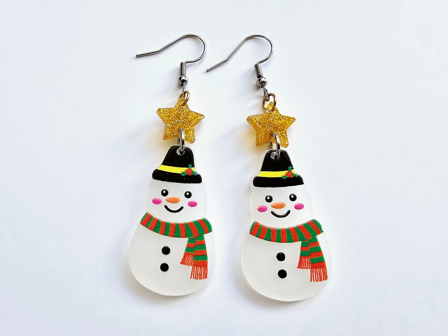 Snowman earrings with gold stars.