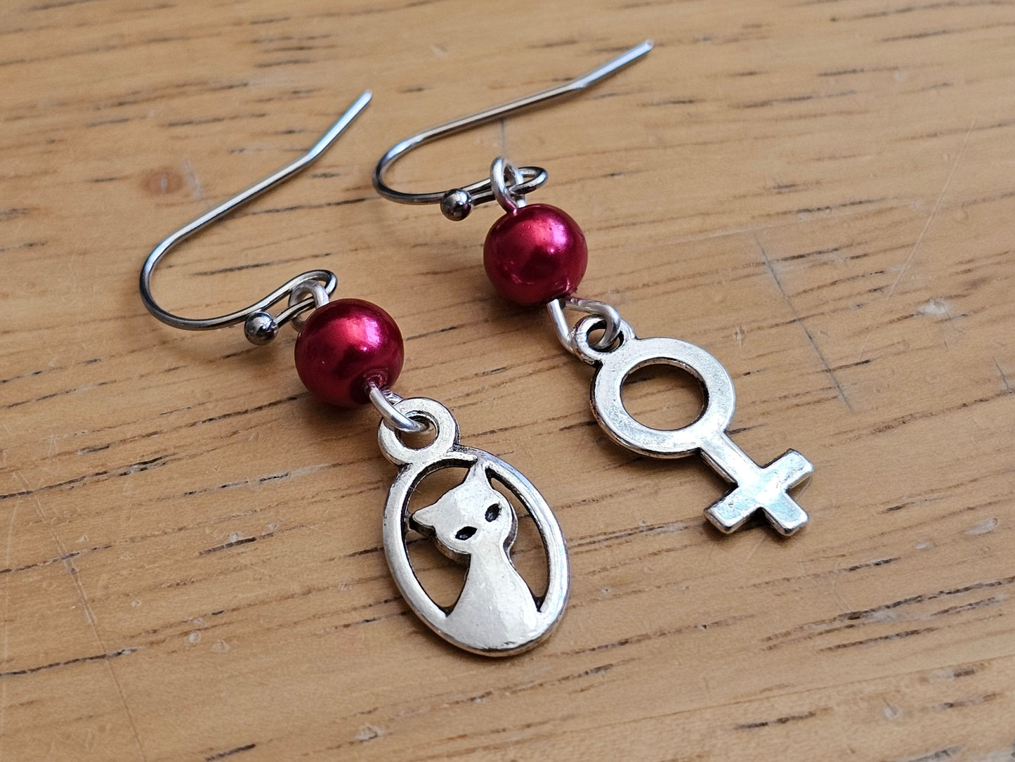 Cat and woman symbol earrings mismatched earrings