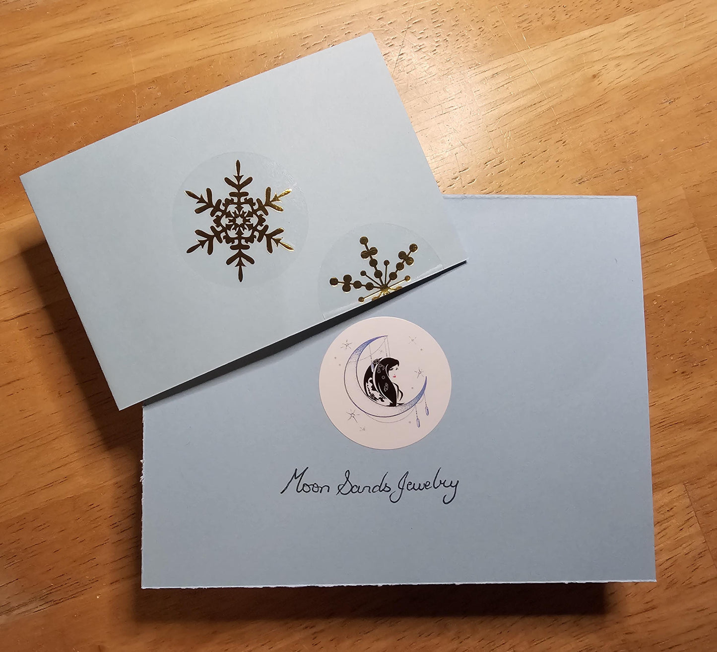 a pair of greeting cards with a snowflake on them