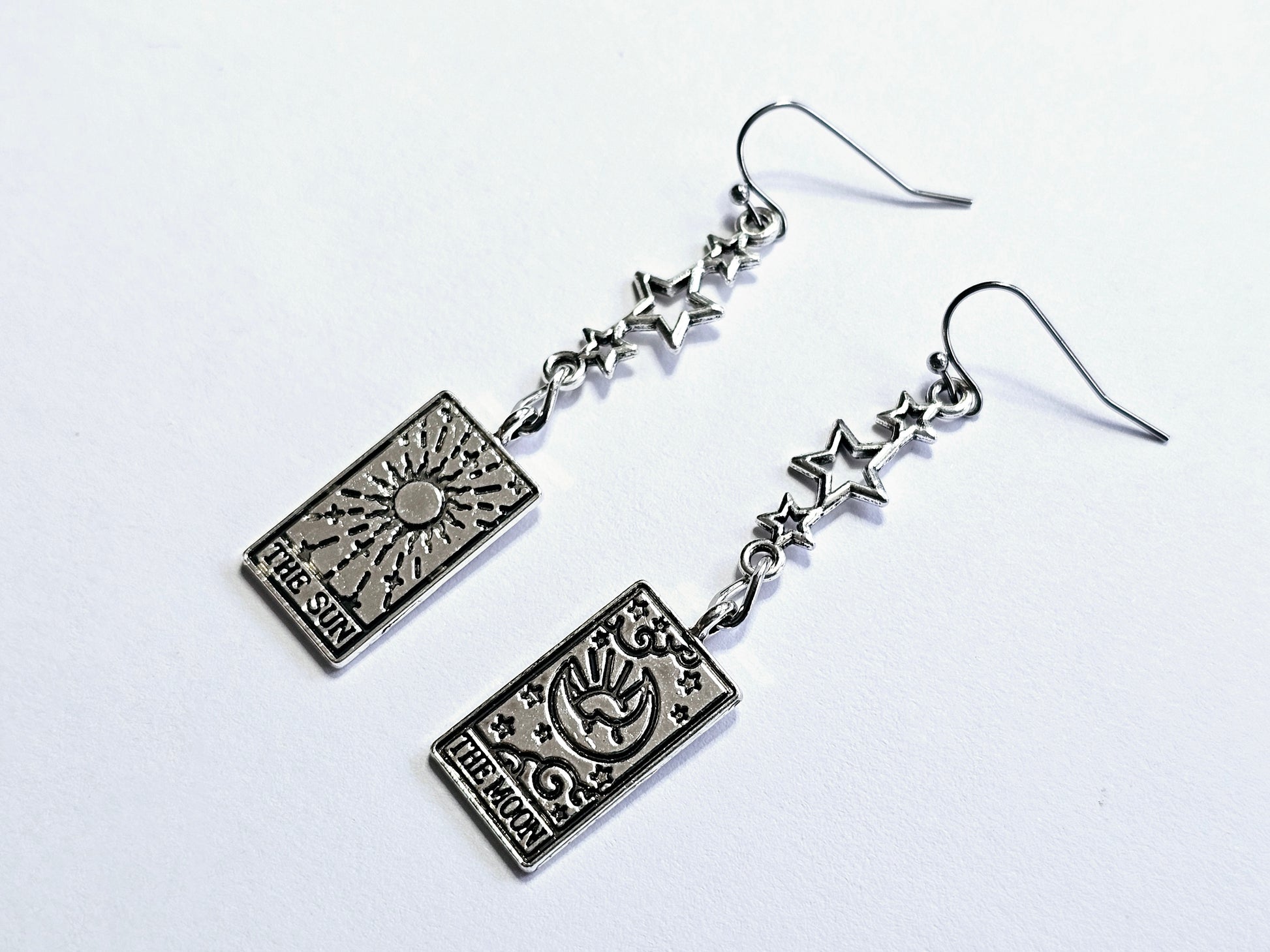 a pair of earrings with a design on them