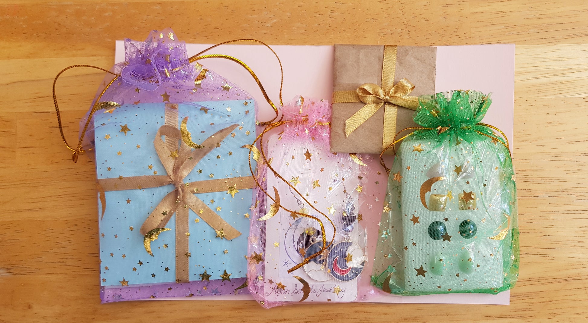 a group of wrapped presents sitting on top of a wooden table