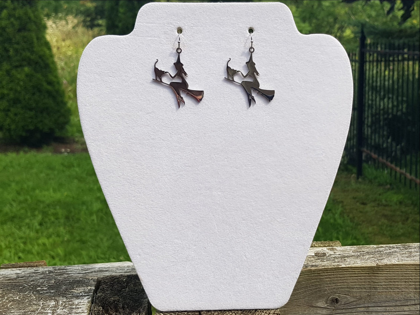 Witch statement earrings. Featuring a witch on a broom with her cat familiar.