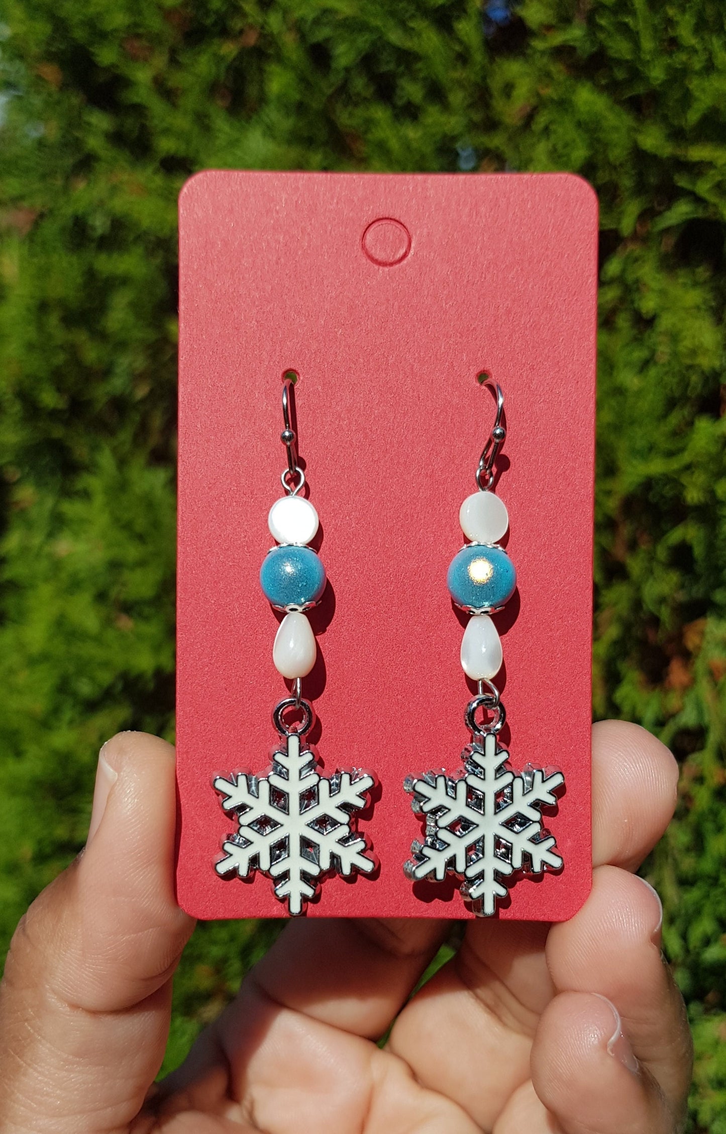 Mother of pearl white and blue snowflake earrings with hypoallergenic surgical steel or titanium ear wires.