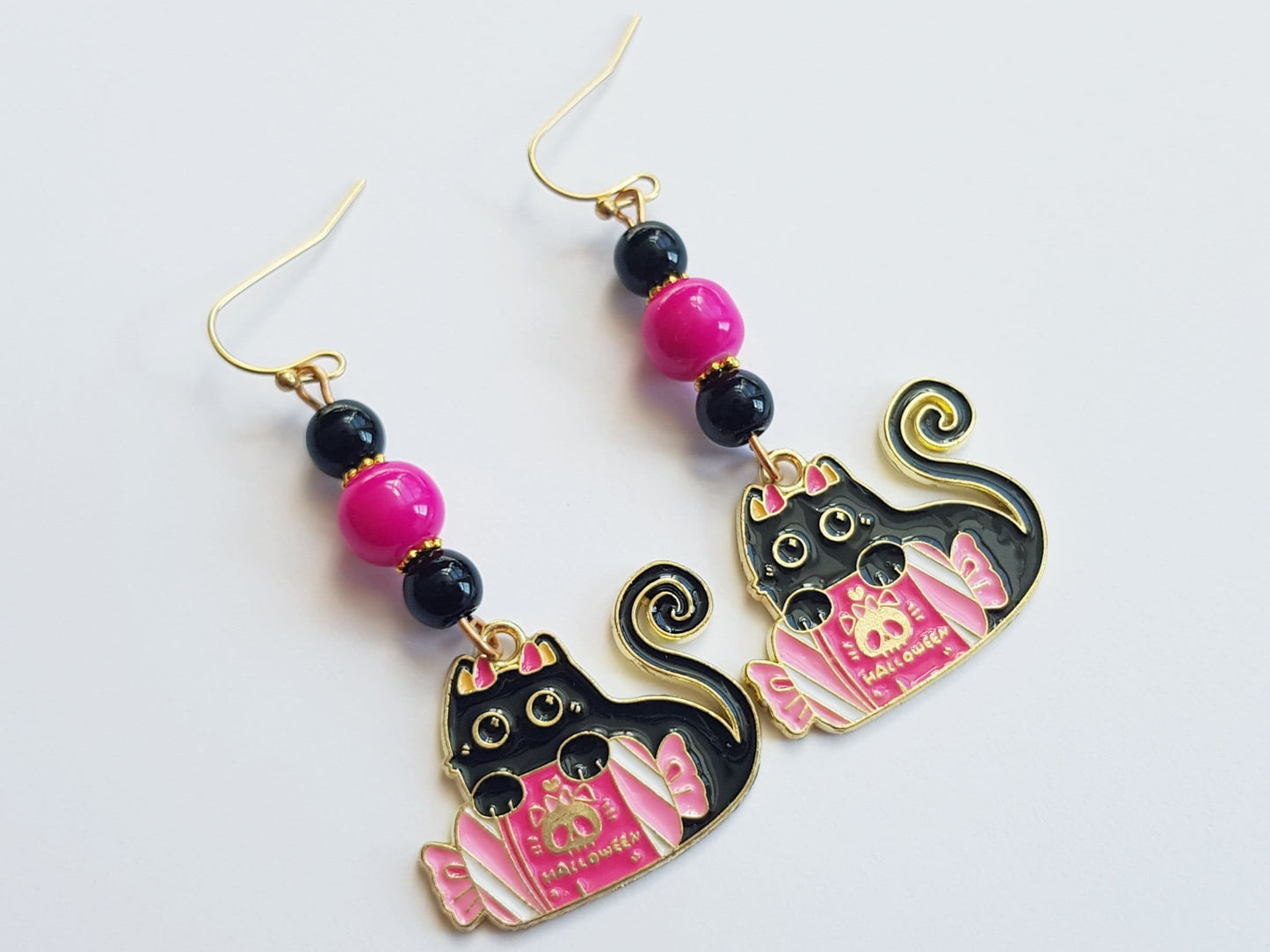 Halloween candy black cat earrings with pink and black beads.