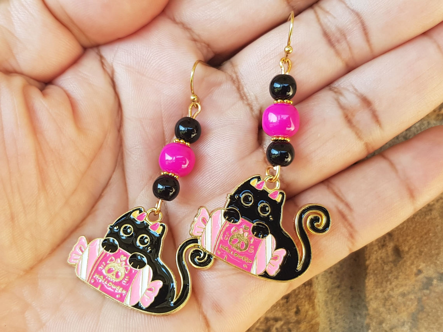 Hypoallergenic, adorable, beaded black cat earrings with Halloween candy available in two bead colour options. Pink and black or pink and white.