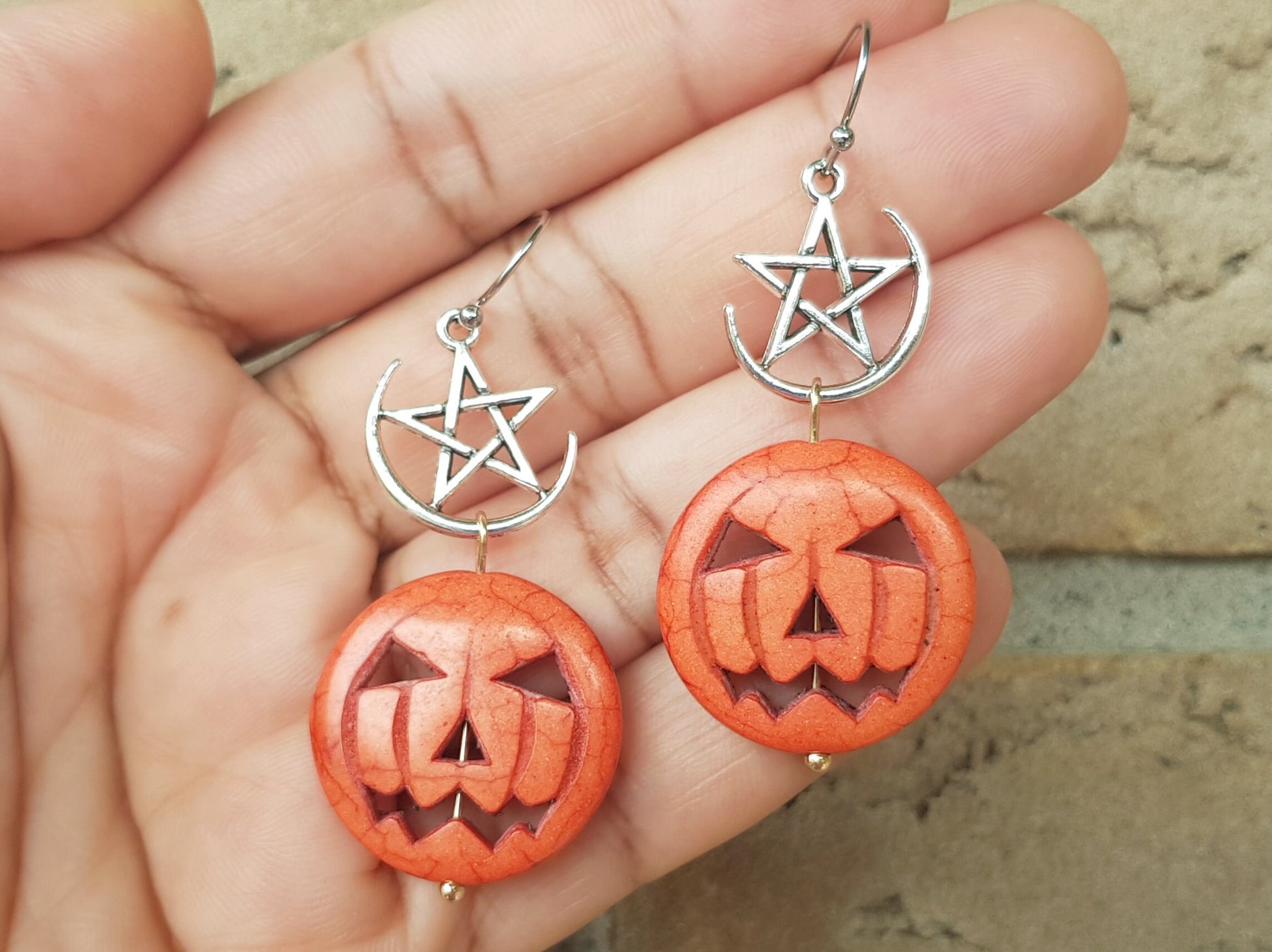 Jack-o&#39;-lantern earrings with hypoallergenic ear wires (surgical steel or titanium) and a pentagram or pentacle detail.