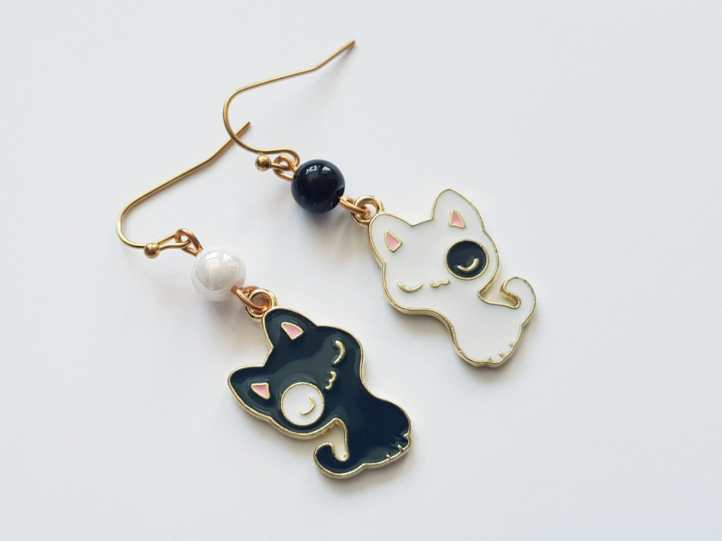 Black and white cat earrings with matching beads and gold plated surgical steel ear wires.