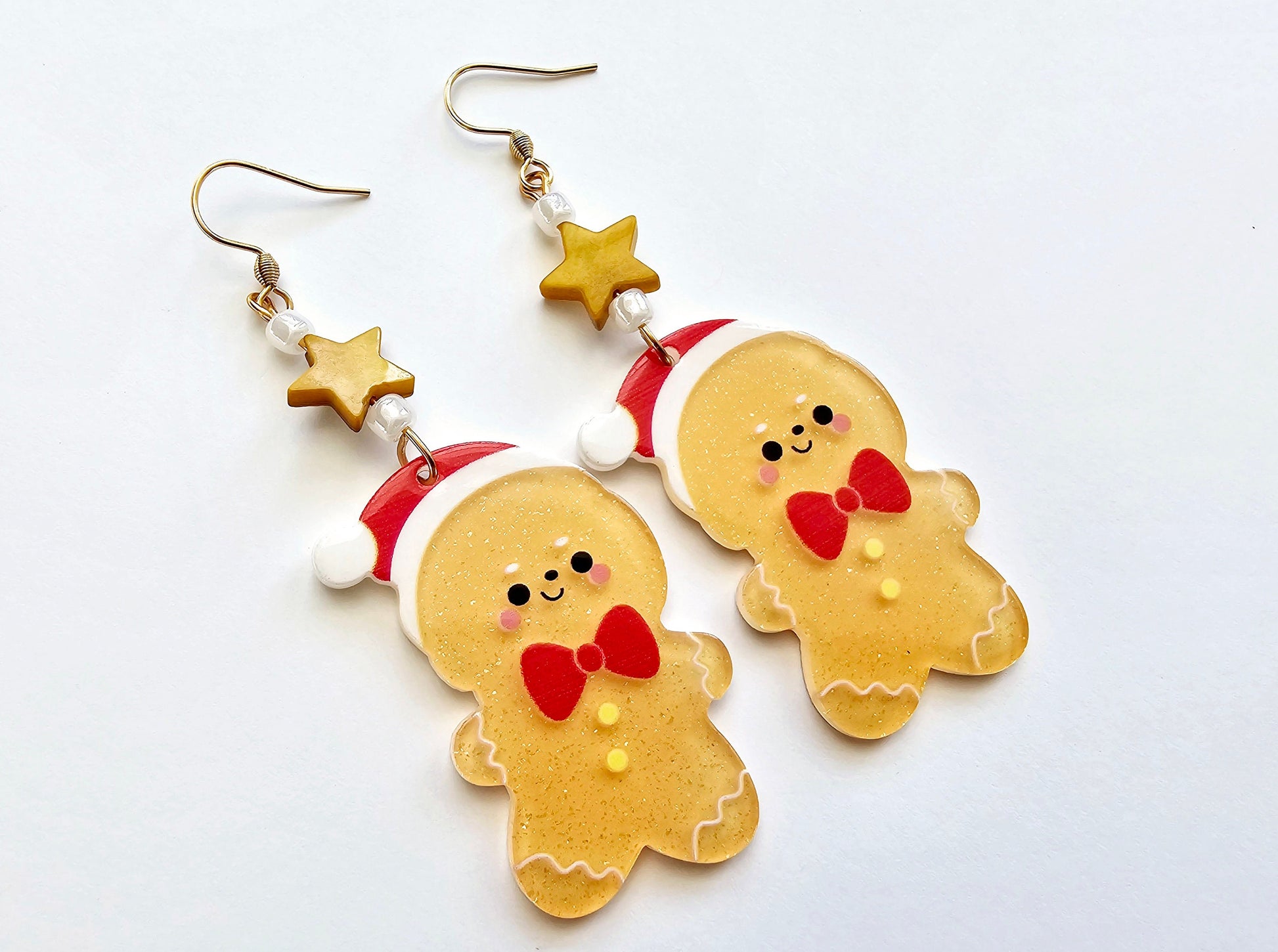 Gingerbread cookie earrings with hypoallergenic surgical steel or titanium ear wires.