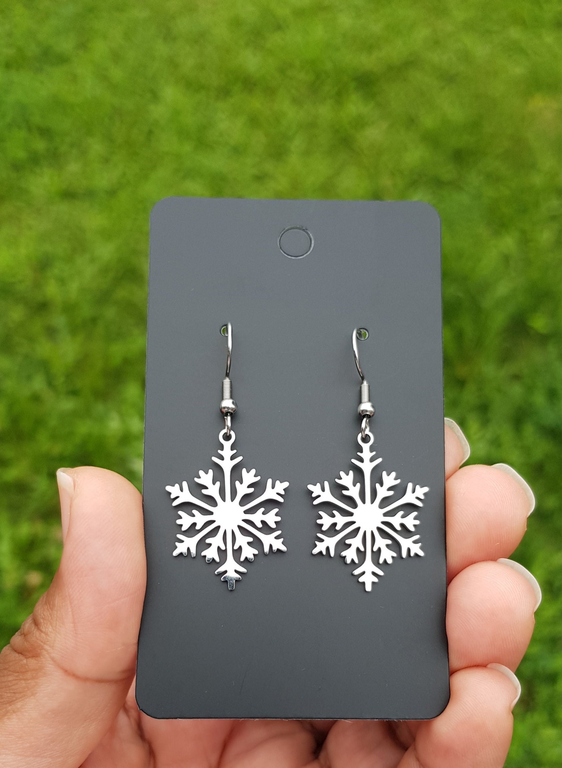 Stainless steel snowflake earrings with hypoallergenic titanium or steel ear wires.