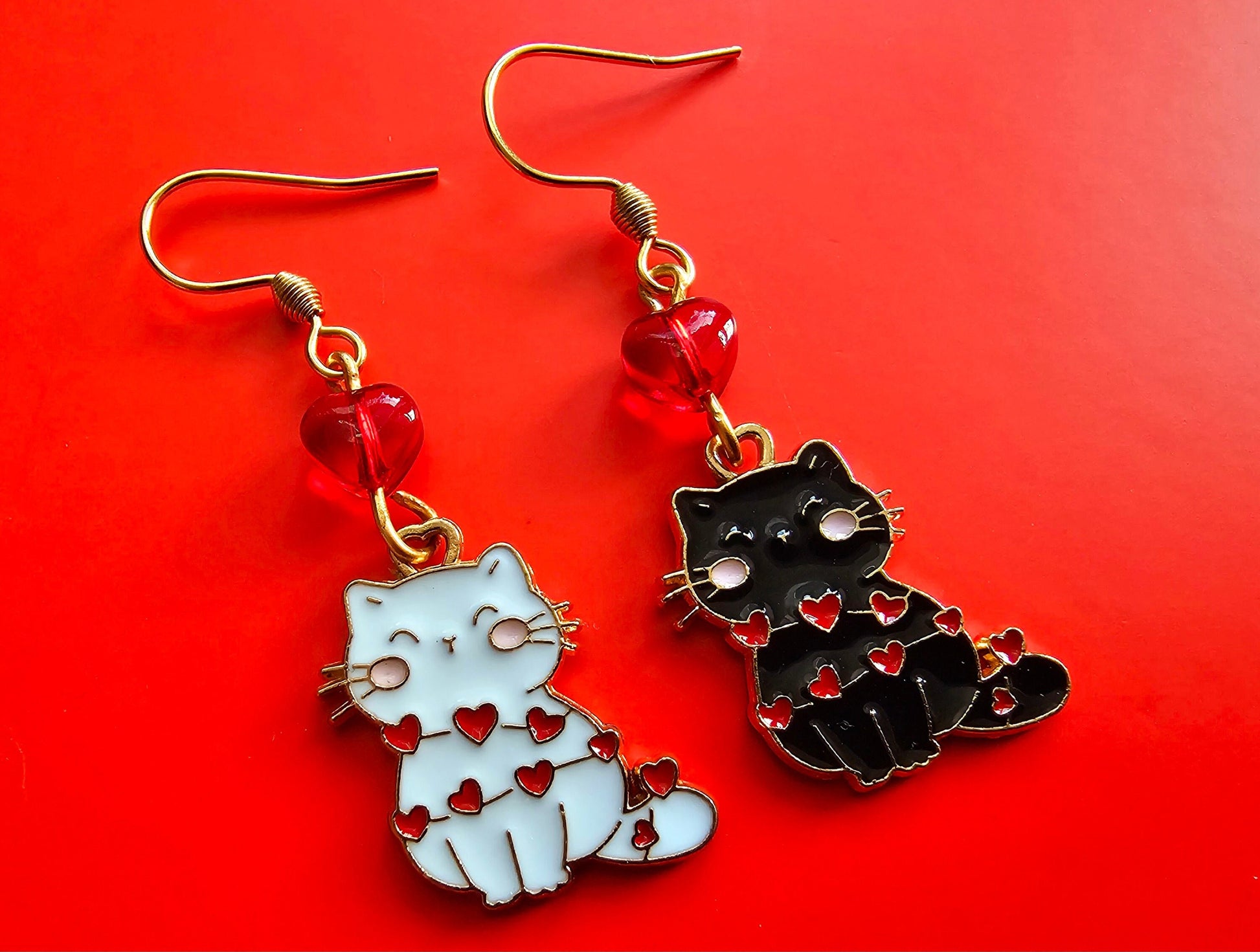 Black and white cat earrings with Christmas lights.